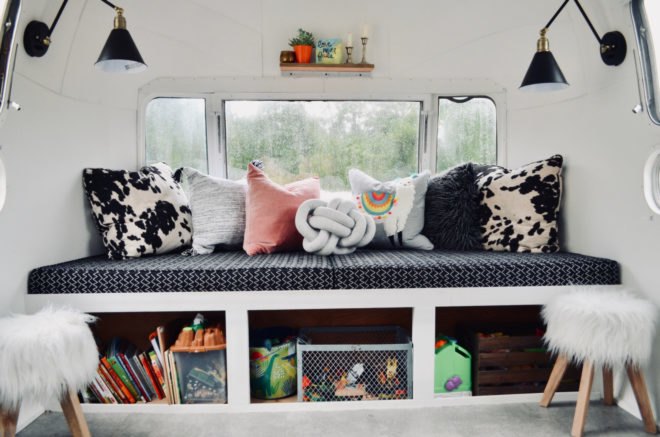 a black and white sofa with lots of pillows