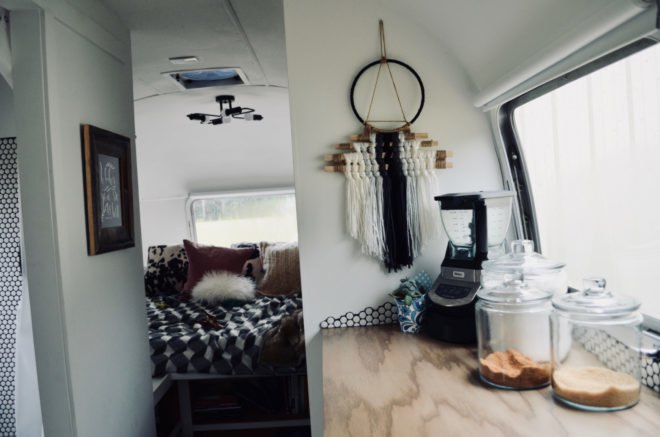 kitchen with wood countertops and bedroom in background