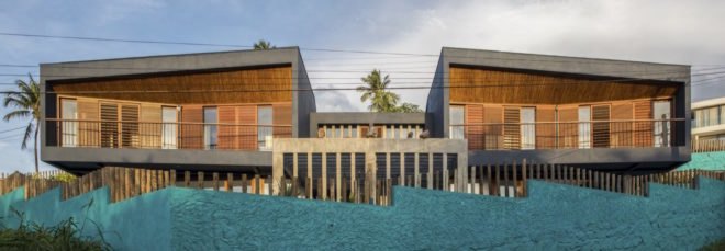 cropped close-up of timber homes with bright blue jagged fence