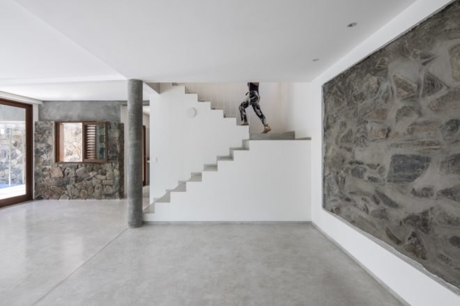 person walking up white staircase