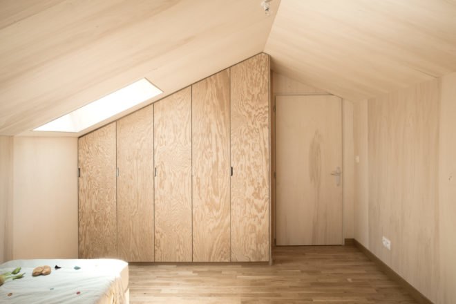 bedroom with natural wood paneling