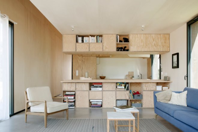 living space with seating and kitchen in the background