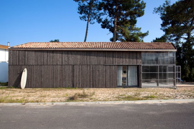 elongated timber home with gabled roof