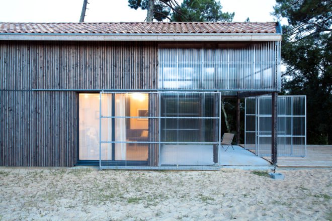 timber home with transparent front porch and gabled roof