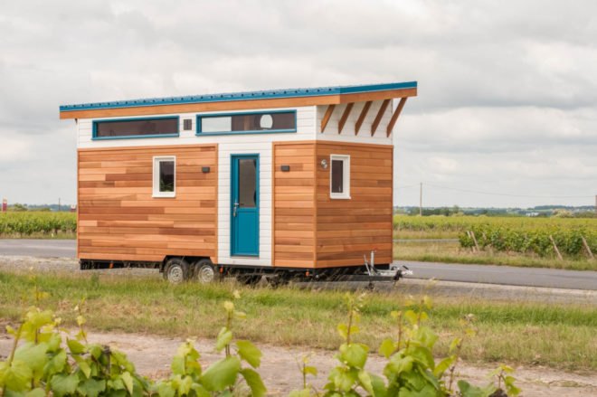 tiny home clad in cedar panels with white trim
