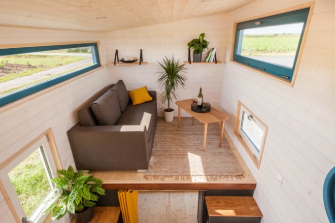 an elevated living area with brown sofa