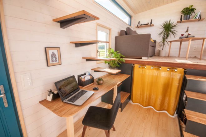 a desk and chair with floating stairs