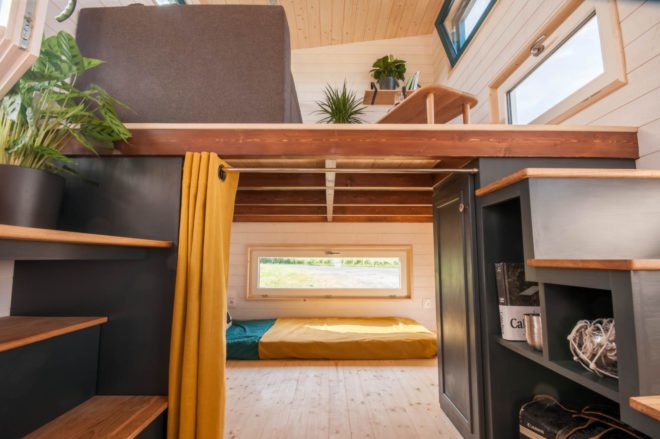 small room separated by yellow curtain