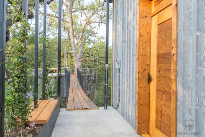 suspension bridge leading to wooden door