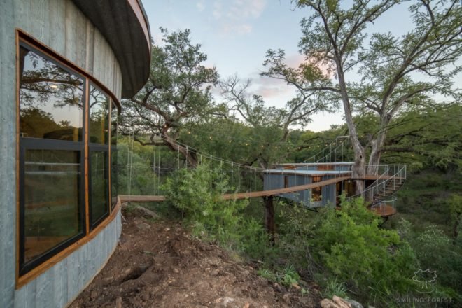 suspension bridge with platforms leading to a treehouse