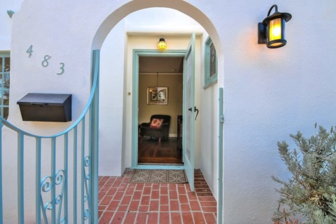 arched doorway into white home