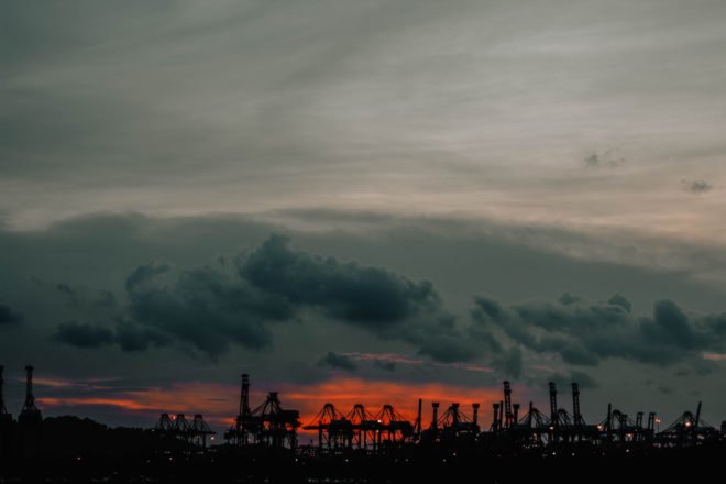 factories and oil drillers at sunset