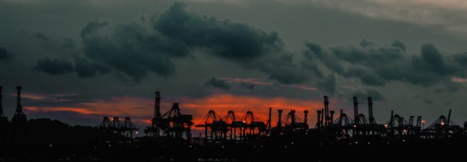 factories and oil drillers at sunset