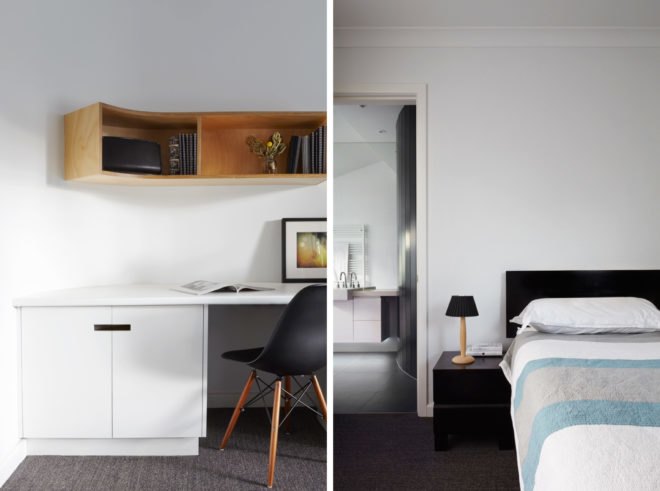 white bedroom with black headboard, gray and blue bedding and a white desk