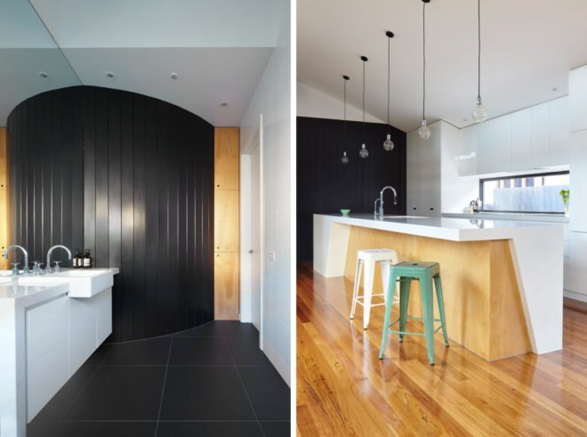 curved black wall in a white and light wood kitchen