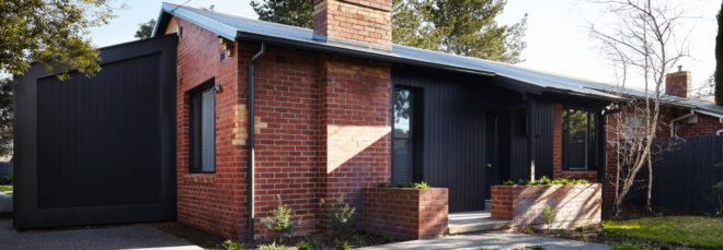 black timber and brick mid-century home