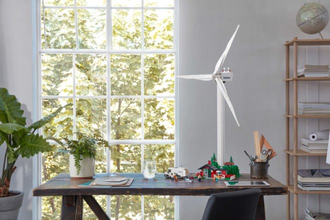 wind turbine and cottage all made from LEGOs on a dining table