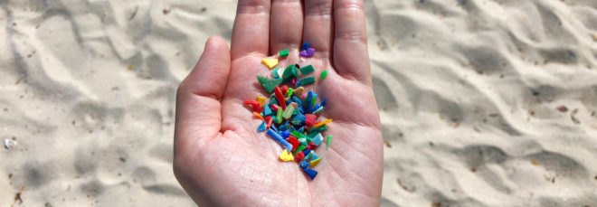 handful of tiny, colorful plastic bits on a beach