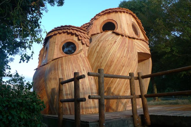 wooden tiny home in the shape of two owls
