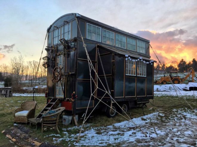 black tiny home with pirate ship details and decorations