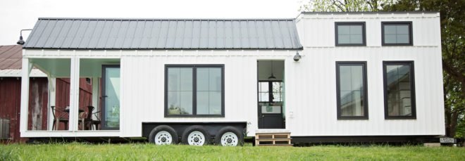 extended white tiny home on wheels