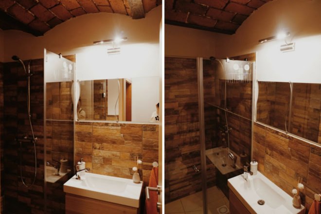 bathroom with wood walls and large sink