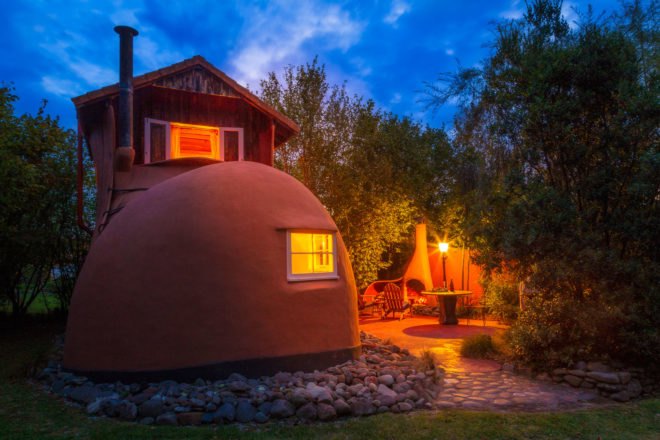 house shaped like a boot lit up at dusk