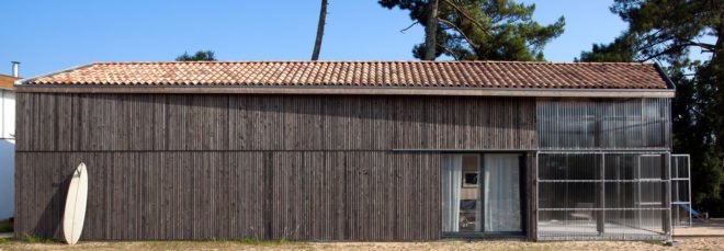 elongated timber home with gabled roof