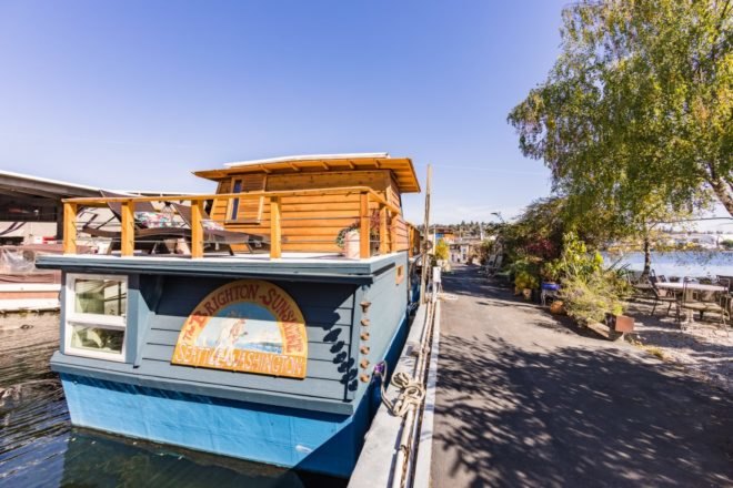 a blue houseboat on a dock