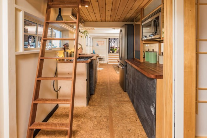 a ladder at the end of a kitchen