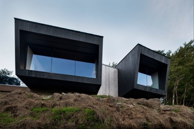 two black cabins with front glass walls