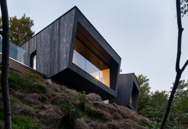two black cabins with glass facades