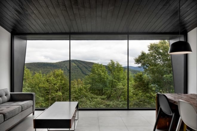 large glass window looking out over forest