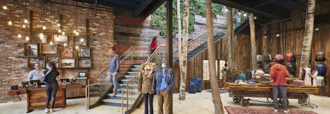 people walking through wood-lined retail store