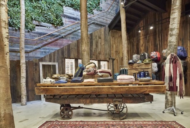 old wood wagon table holding outdoor clothing