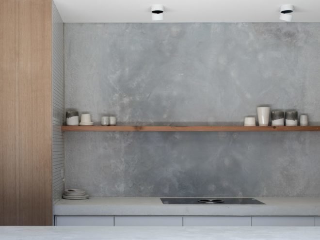 concrete and marble kitchen with thin wooden shelf