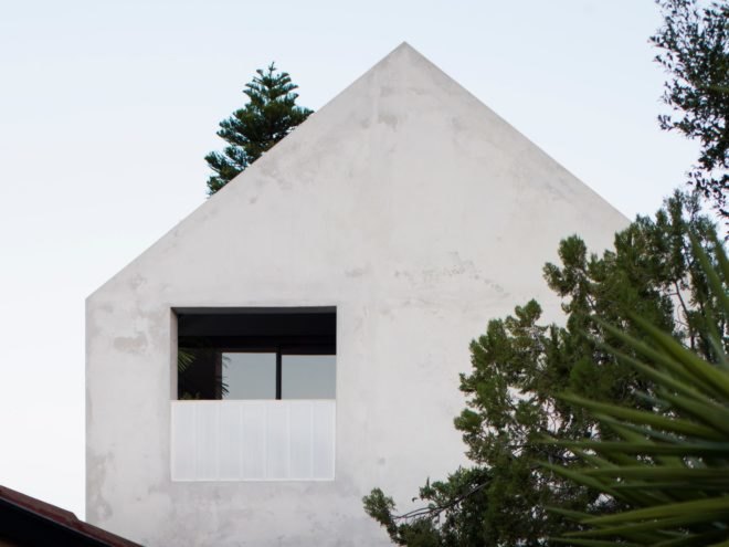 A-frame concrete home with large window