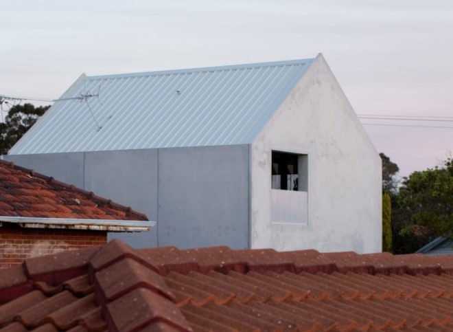 A-frame concrete home with large window
