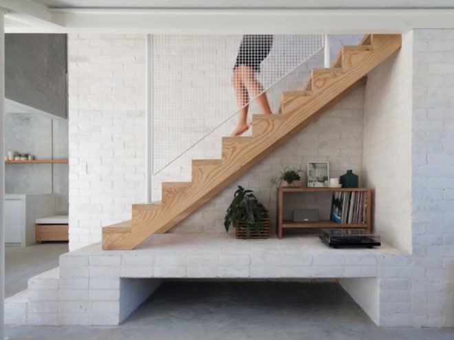 person walking down a wooden staircase