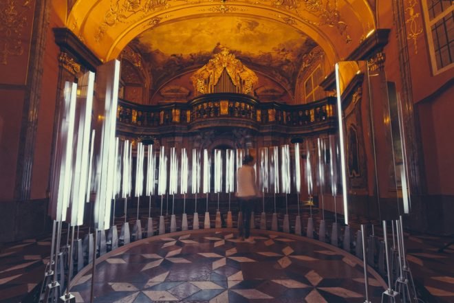 one person inside circle of mirrors