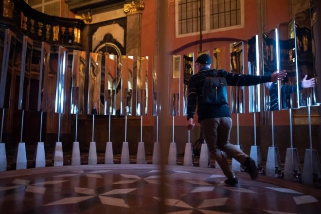 person running inside circle of mirrors