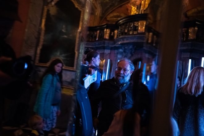 man looking at mirrors