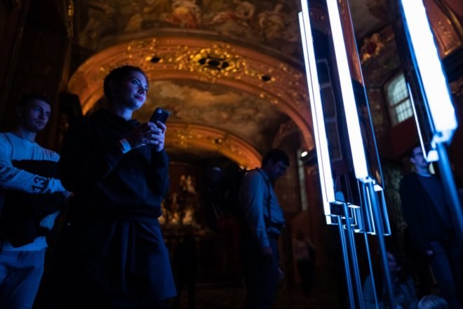person looking at LED-lit mirror