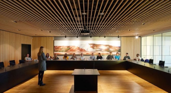 people sitting at long table in meeting room