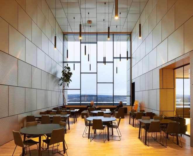 room with tables, chairs and a glass wall