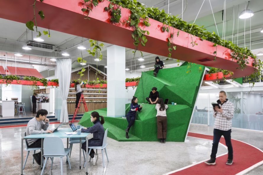 people leaning on a tall green volume