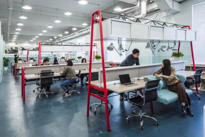 people working at wooden desks