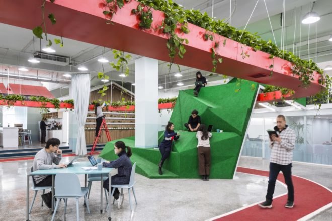 people leaning on a tall green volume
