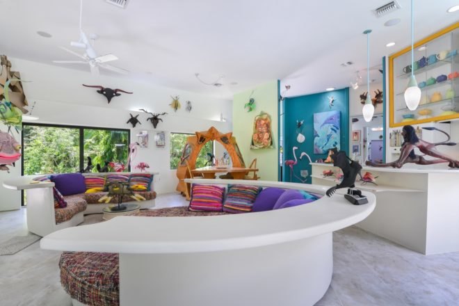 curved white couch with colorful pillows and cushions