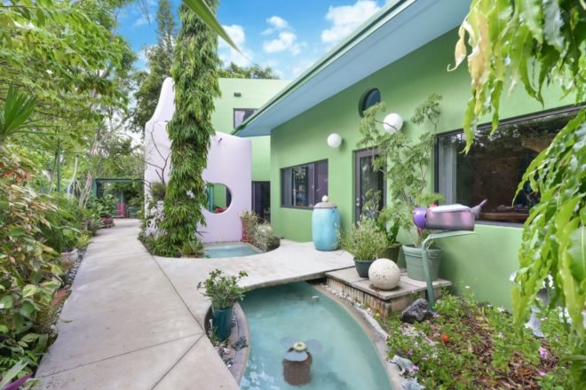 green and white home with pond